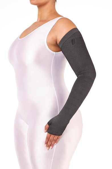 Female wearing a white body suit and a JOBST Confidence black arm sleeve garment.