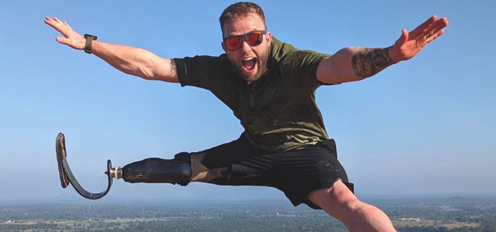 Jamie Gane jumping high in the air with arms and legs spread wide