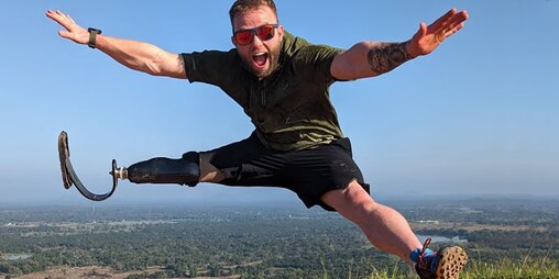 Jamie Gane jumping high in the air with arms and legs spread wide