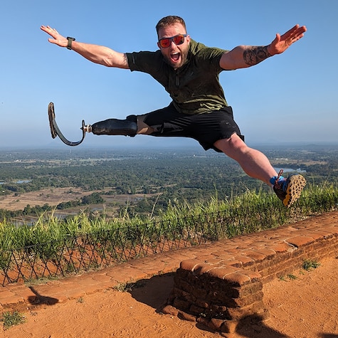 Jamie Gane jumping high in the air with arms and legs spread wide