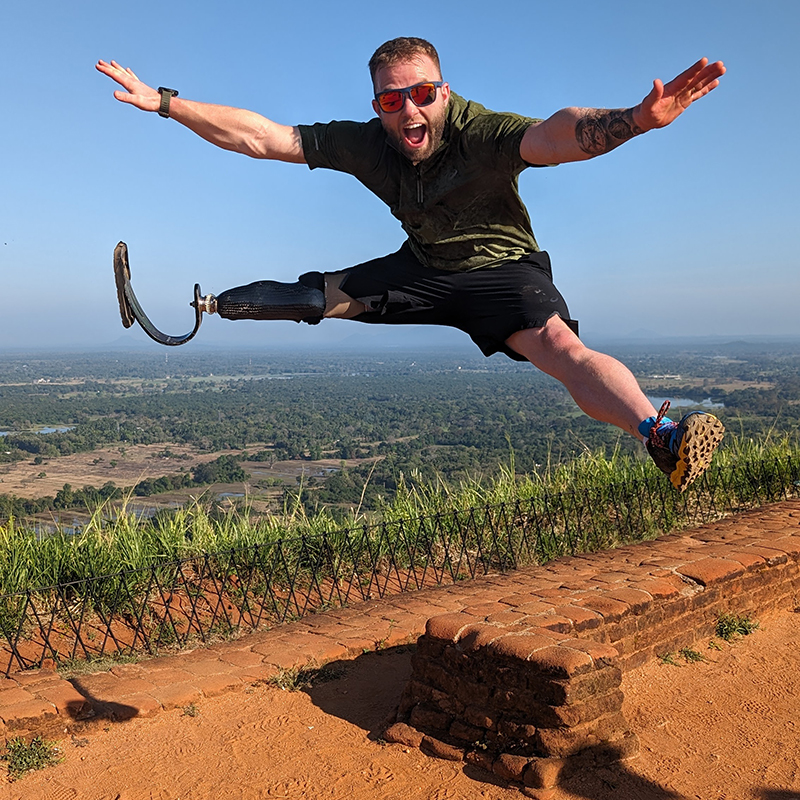 Jamie Gane jumping high in the air with arms and legs spread wide