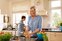 Woman wearing Actimove Professional Line Rhizo Forte Thumb Orthosis, peeling vegetables in her kitchen
