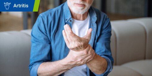Persona lleva puesta la muñequera para tendinitis Actimove Sports Edition para recuperarse.
