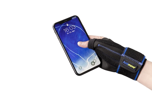 Close-up of person wearing Actimove Sports Edition Thumb Stabilizer holding phone
