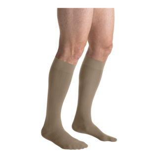 A close-up of legs in khaki-colored JOBST knee-high closed-toe compression stockings.
