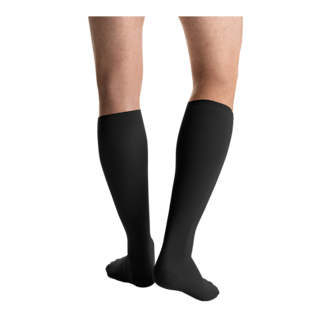 Close-up rear view of a person wearing a pair of JOBST Travel compression socks in black.