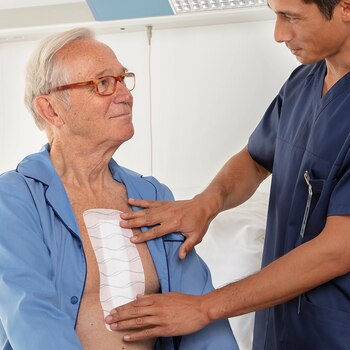 Hypafix skin sensitive by Leukoplast, close-up view plaster on chest of elderly man