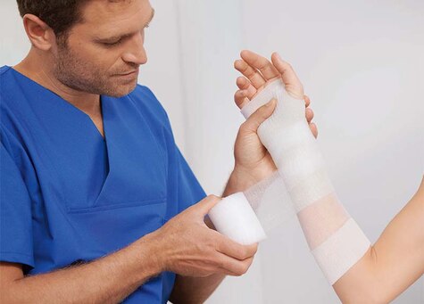 Close-up of a person's arm wearing a cast tape 