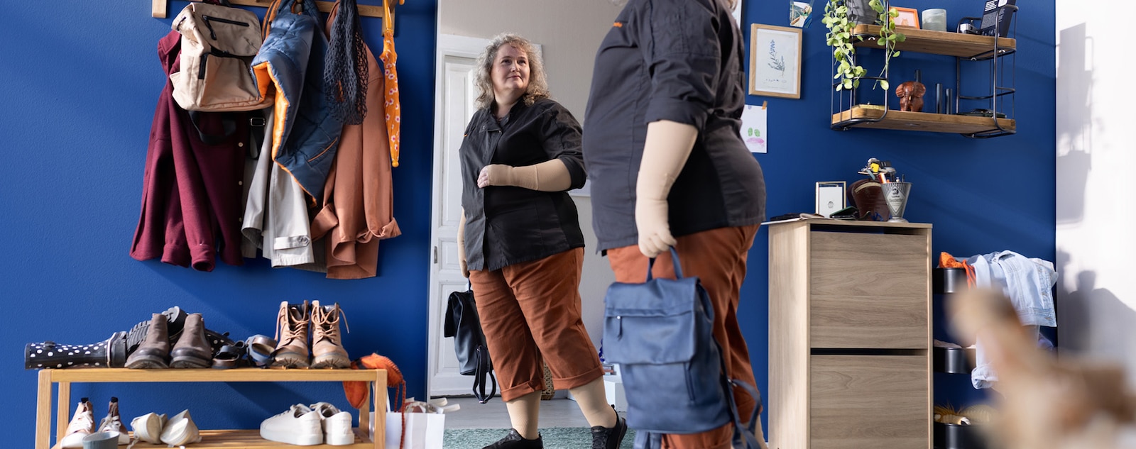 A woman looks at herself in a mirror.