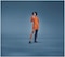 Female in an orange dress wearing the JOBST Elvarex Soft dark blue compression garment for lipoedema.