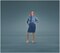 A woman wearing glasses standing against a plain blue background with both hands on her hips, dressed in a blue shirt, blue skirt, orange shoes, and JOBST Relief compression stockings.