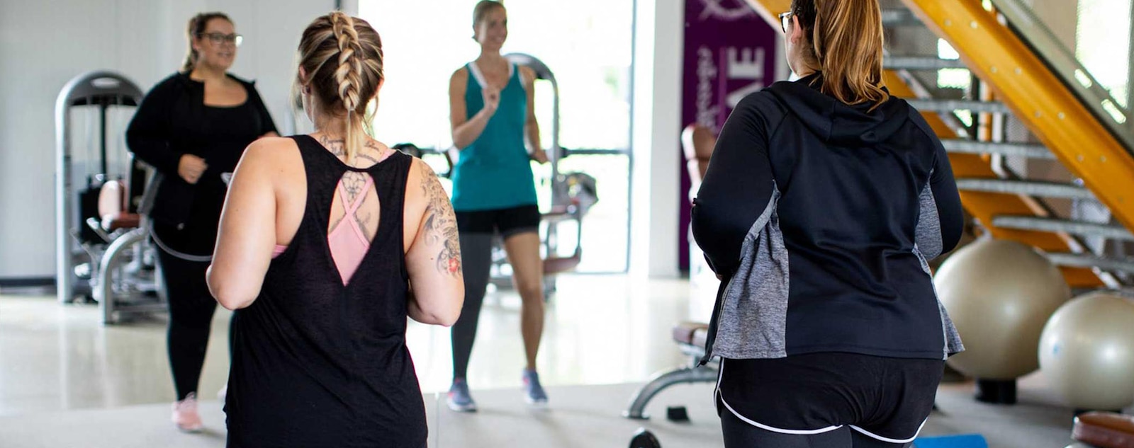 People wearing compression garments while working out in a gym.