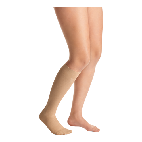 Right leg wearing a JOBST Confidence knee-high closed toe beige leg compression garment.