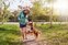 Woman outdoors playing with her dog, wearing the Actimove Everyday Supports Knee Support with Closed Patella with 2 Stays
