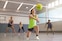 Woman playing volleyball, wearing Actimove Sports Edition Ankle Support Elastic Wrap Around
