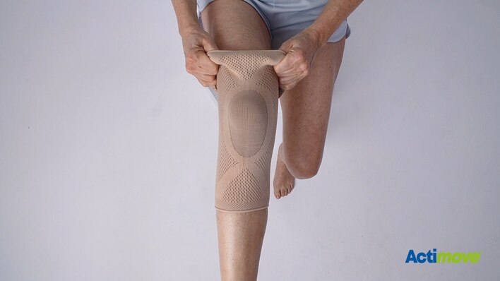How to put on the Actimove Everyday Supports Knee Support with Closed Patella: pull the knee support up your leg
