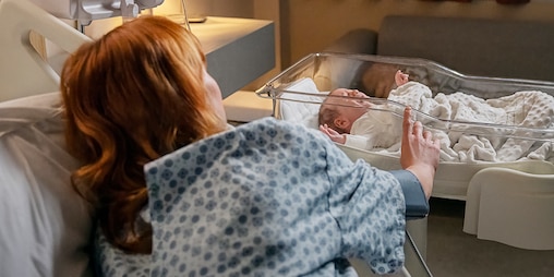 Surgical Site Infection prevention with Leukoplast wound dressings in hospital maternity ward showing patient and newborn baby.