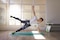 Men at gym performing side plank exercise, wearing an Actimove Sports Edition Back Support with 4 Stays
