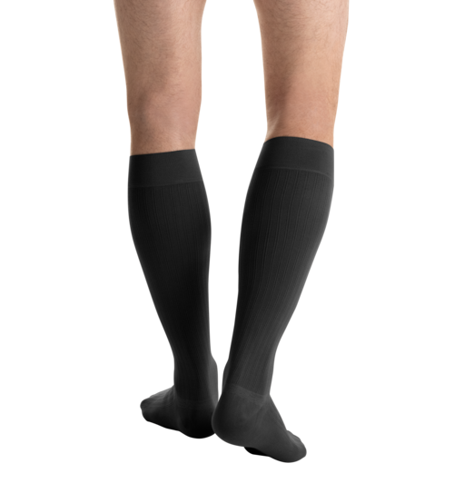 Close-up side view of a person 
wearing JOBST for men ambition Knee High Closed Toe Dark Grey