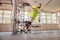 Man working out at gym, wearing Actimove Sports Edition Knee Brace Wrap Around with Polycentric Hinges and Condyle Pads
