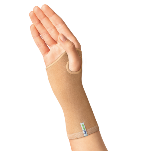 Hand wearing beige knitted Actimove Wrist Support for arthritis 
