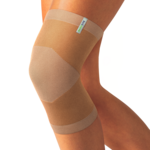 Beige knitted Actimove Arthritis Care Knee Support with heat reflecting technology on slightly bent knee 
