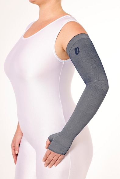 Female wearing a white body suit and a JOBST Confidence arm sleeve garment.