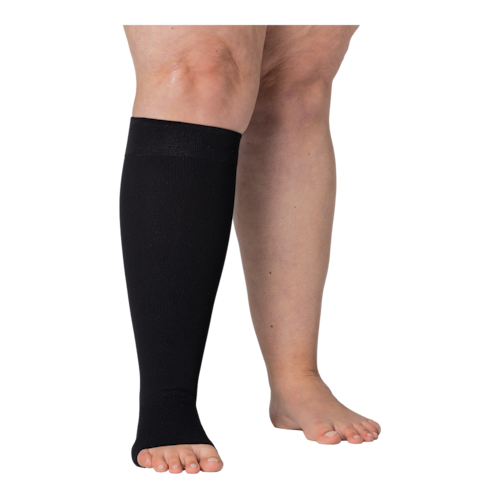 Right legs wearing JOBST Elvarex compression black knee stockings.